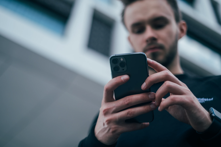 A person checking a gift card trading rate on a phone before starting a trade