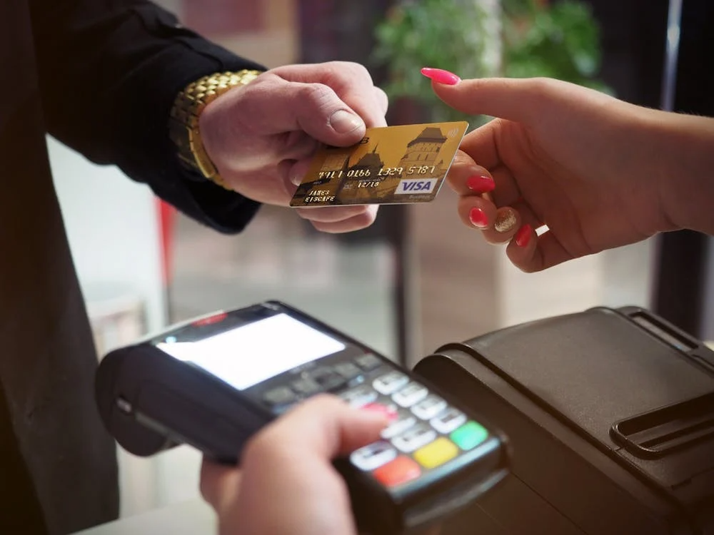 Card processing fee breakdown beside a stablecoin transfer cost on an efficient chain