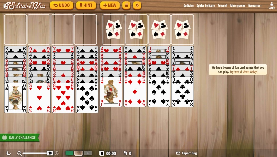 Solitaire Bliss FreeCell board with illustrated cards on a wood background